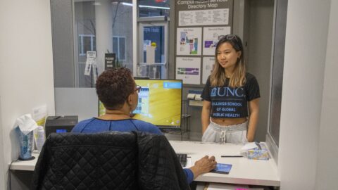 Student speaks to a check in staff