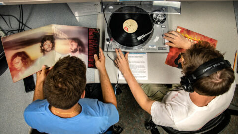 Students play a record at library