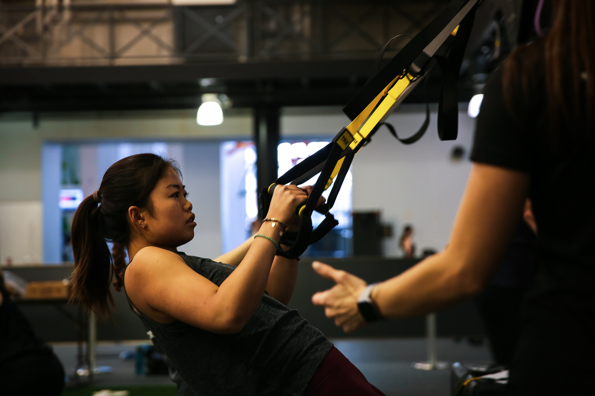 student in Heel Fit uses TRX as resistance training