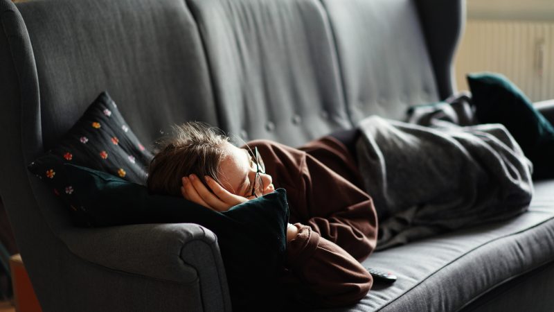 person sleeps on couch