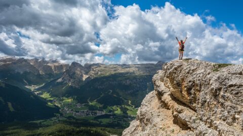 Person stands on mountaintop