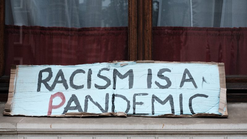 Racism is a Pandemic handwritten sign
