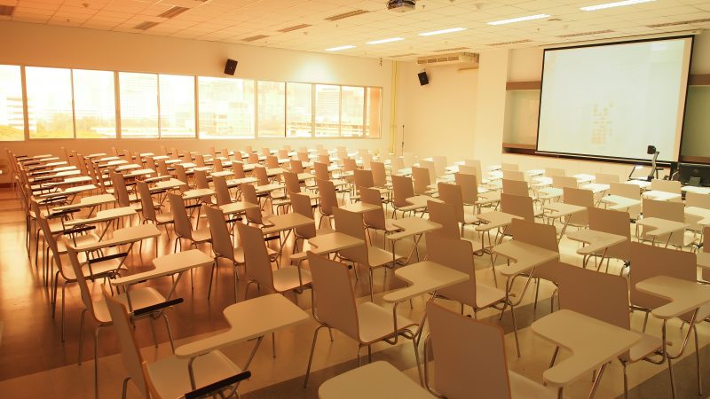 A pattern of chairs and desks in the classroom in the morning before class