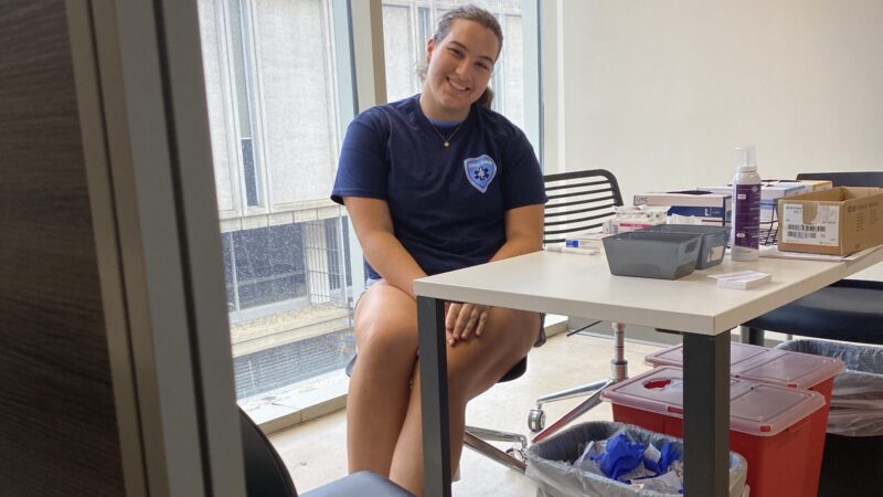 A student employee at the Mini Clinic poses for photo