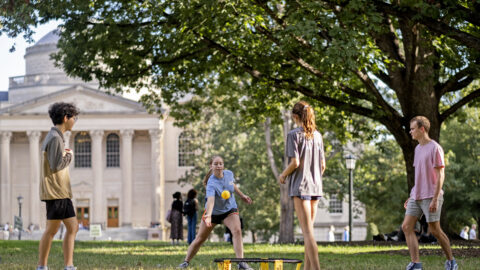 Afternoon scene at Polk Place - students play spike ball